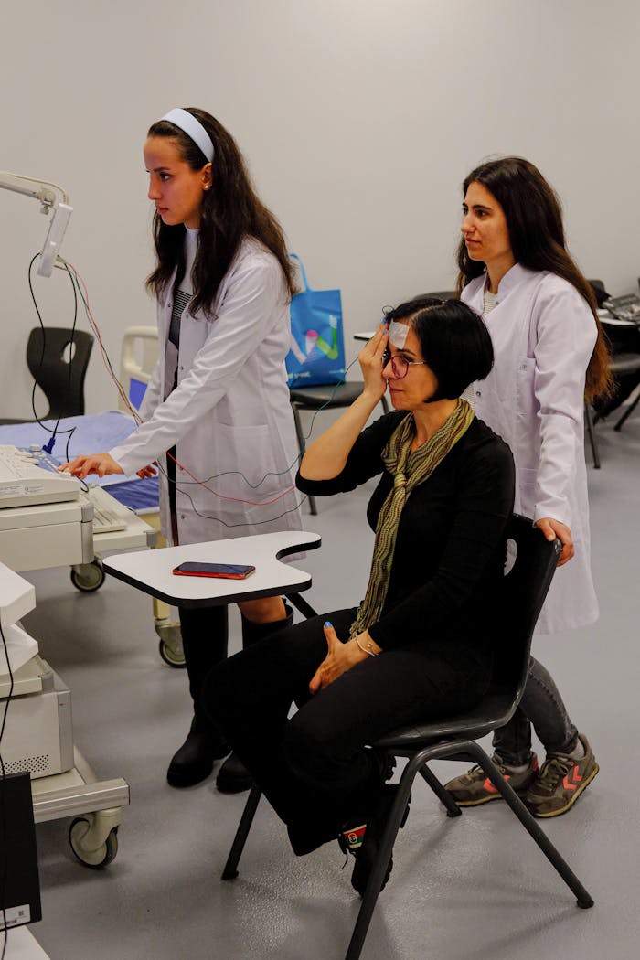 Elderly Woman Getting Her Eyes Tested by Two Young Opticians